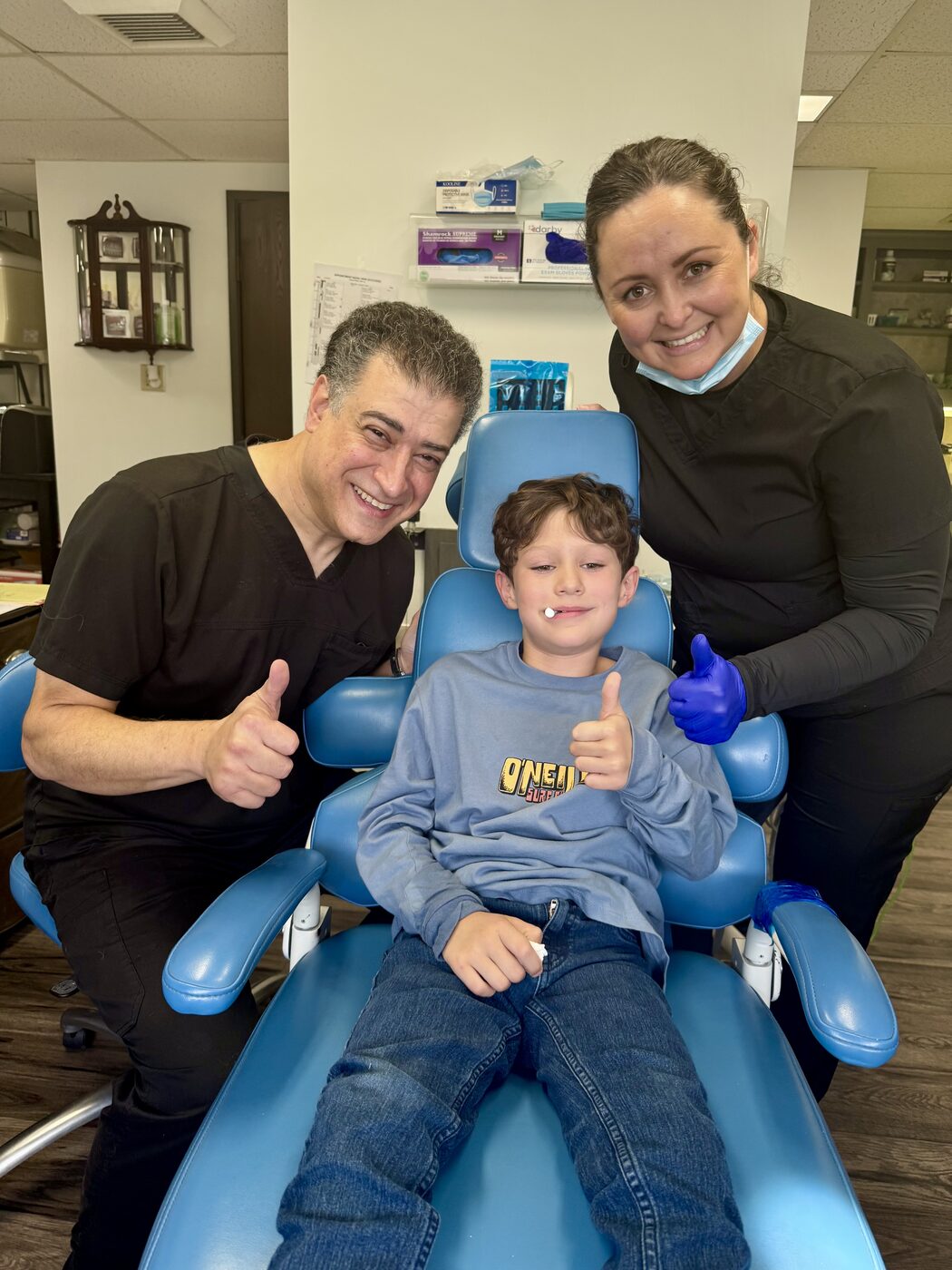 Dr. Rajabi and team with a happy young patient