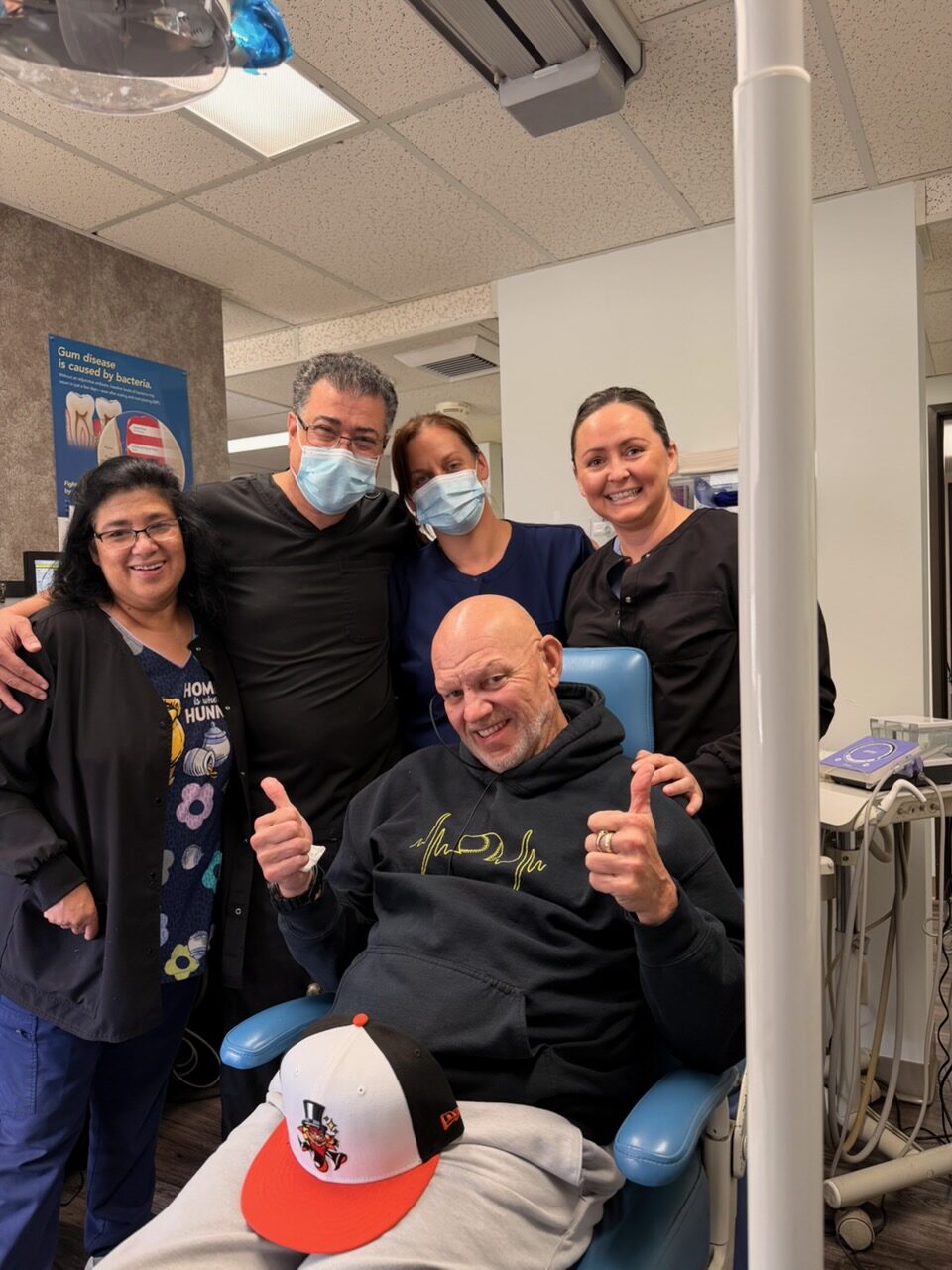A happy patient celebrating with Dr. Rajabi and the team